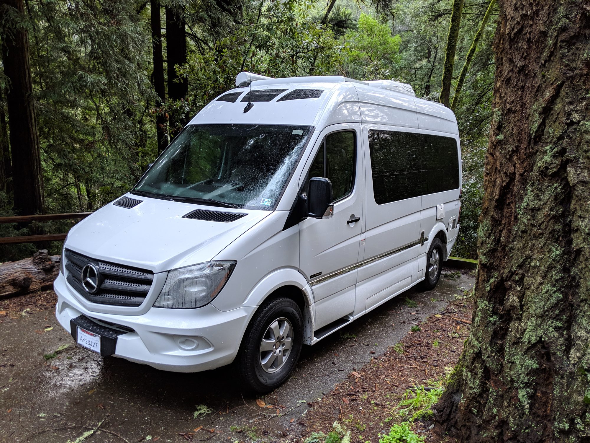 Front three-quarter view of the Roadtrek SS Agile in the redwoods